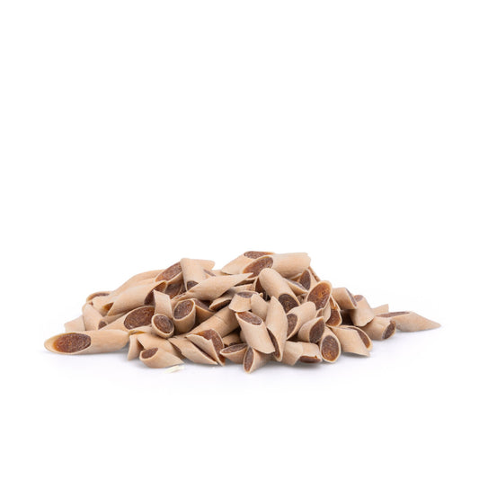 Pack of Merino lamb stick dog treats, low-fat and hypoallergenic, on a green background