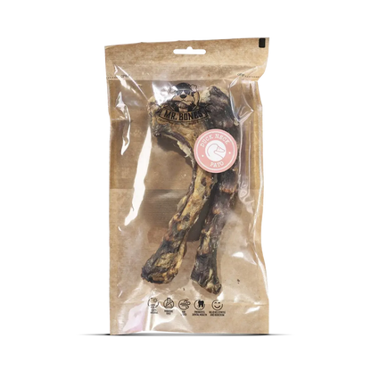 Two air-dried duck neck dog chews on a rustic surface, natural dental snack for dogs.