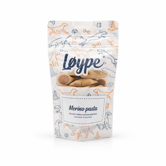 Pack of Merino lamb stick dog treats, low-fat and hypoallergenic, on a green background