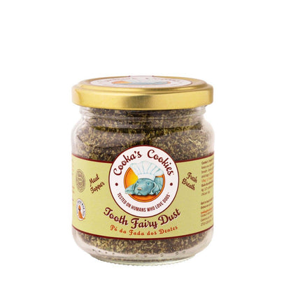 Close up of Tooth Fairy Magic Dust meal topper for dogs and cats, featuring natural seaweed, coconut, and parsley ingredients in a glass jar.